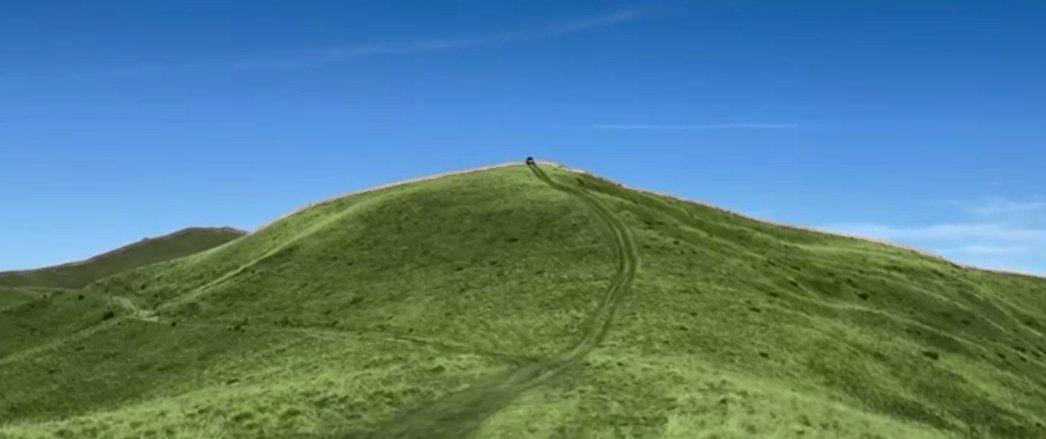 Green grassy ridge with a track leading to the top